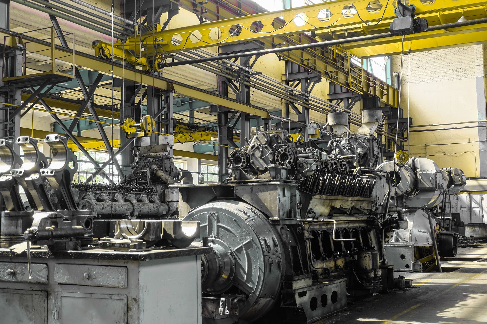 Diesel locomotive engine in a repair depot workshop with overhead crane