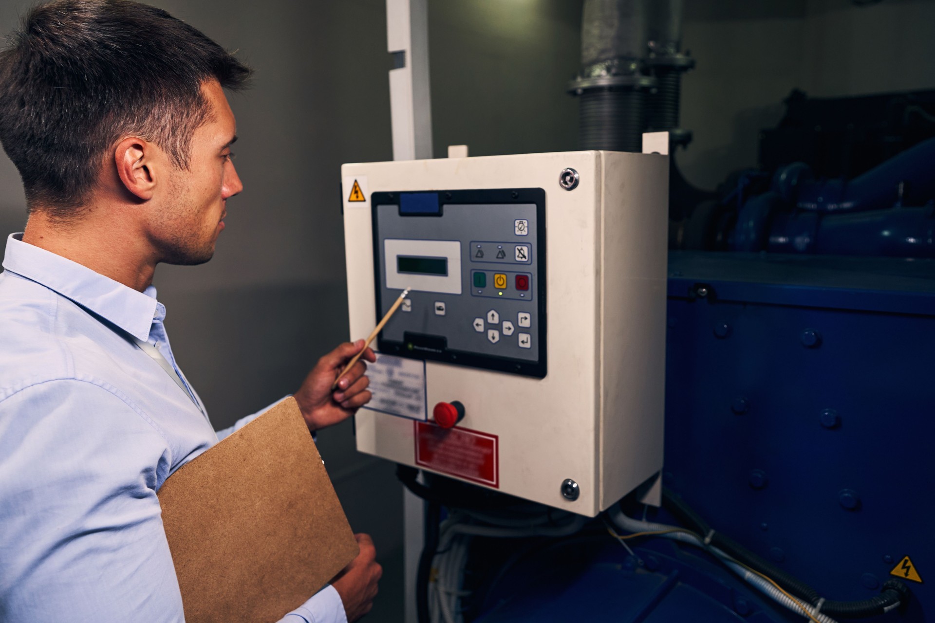 Experienced technician monitoring operation of generating unit